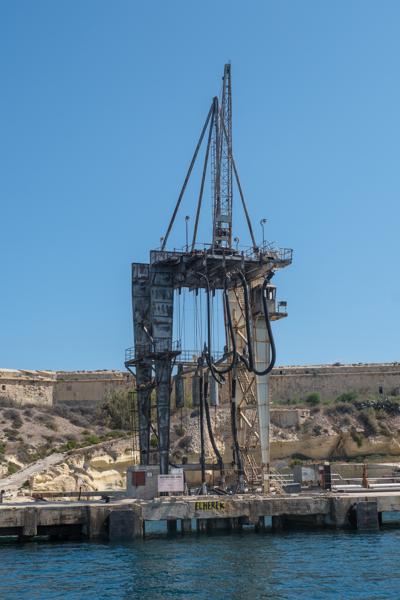 Rusting dockside crane at Kalkara waterfront, Malta Port Region, Malta